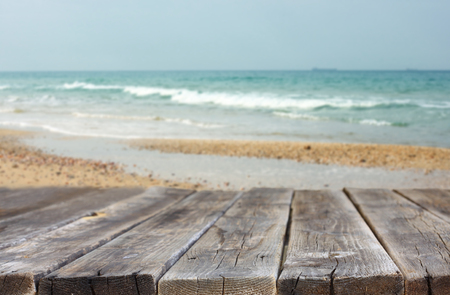 wood planks in front of sea landscape  lens flare  filtered image  の写真素材