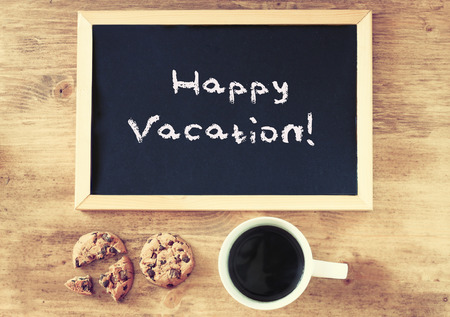 blackboard and the phrase happy vacation written on it   の写真素材