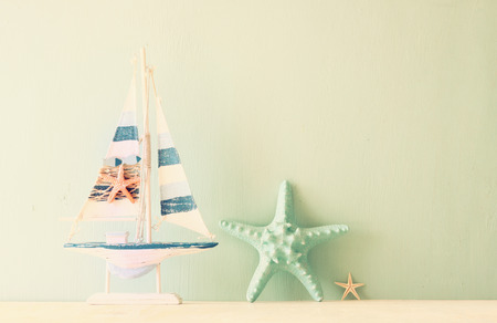 decorative boat and seashell over wooden textured backgroundの写真素材