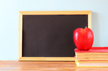 empty blackboard , apple and stack of books  back to school concept   の写真素材