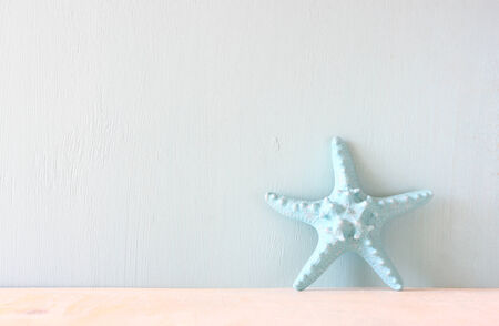 starfish over wooden textured background  の写真素材