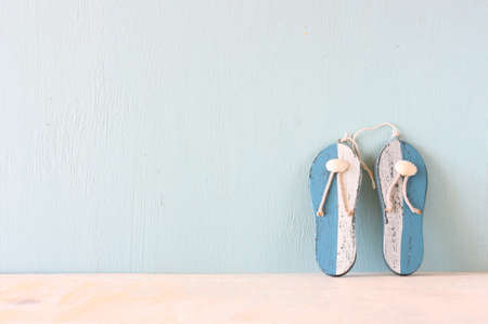 wooden flip flops over white textured background  summer concept の写真素材