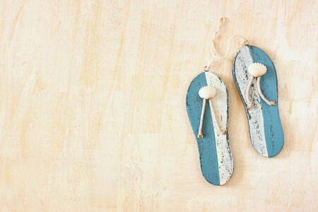wooden flip flops over white textured background  summer concept の写真素材