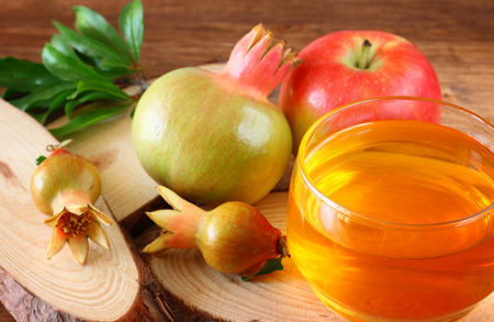 rosh hashanah concept - apple honey and pomegranate over wooden table   の写真素材