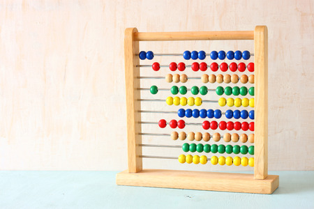 Beaded Abacus over wooden textured background  の写真素材