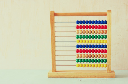 Beaded Abacus over wooden textured background  の写真素材