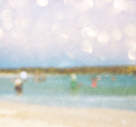 background of blurred beach and sea waves with bokeh lights, vintage filter   の写真素材