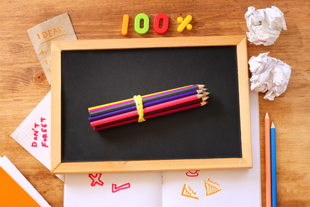 top view of blackboard , stack of pencils and crumpled paper の写真素材