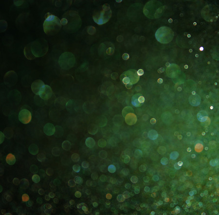 dark green glitter lights background  abstract green and black  defocused   の写真素材