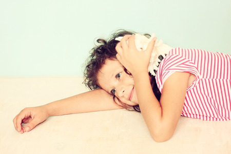 curious kid listen to seashellの写真素材