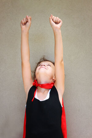 Super hero kid against textured wall backgroundの写真素材