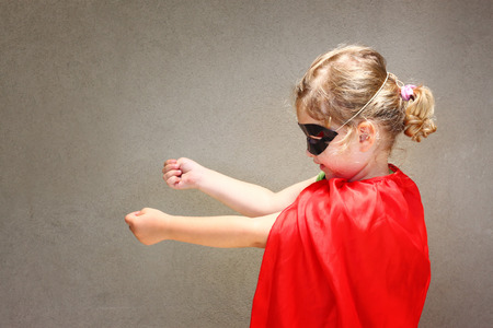 Super hero kid against textured wall backgroundの写真素材