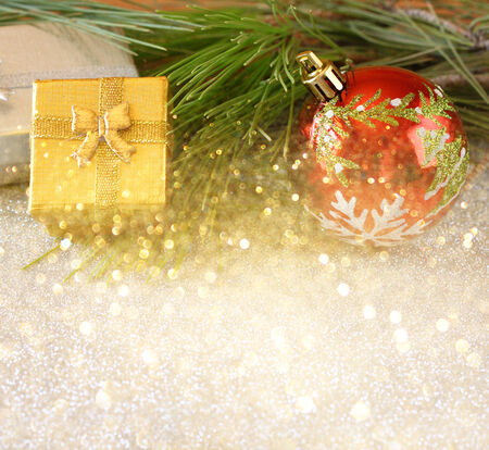 christmas background with ornament, gift box and fir over tableの写真素材