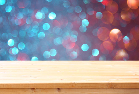 image of front rustic table and colorfull bokeh lights background.  