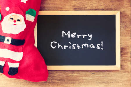 red sock and blackboard with merry christams greetingの写真素材