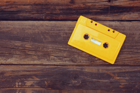 Cassette tape over wooden table. top view. image is retro filtered. room for textの写真素材