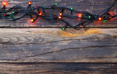 Colorful Christmas lights on wooden  rustic backgroundの写真素材