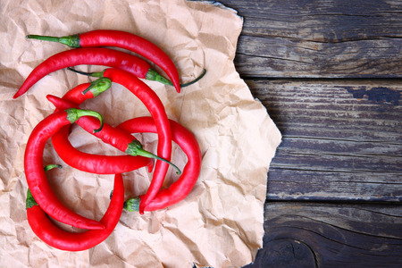 fresh red hot chili peppers on an vintage wooden tableの写真素材