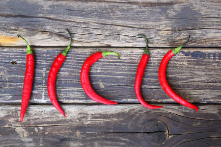 fresh red hot chili peppers on an vintage wooden tableの写真素材
