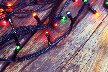 Colorful Christmas lights on wooden  rustic background. filtered imageの写真素材
