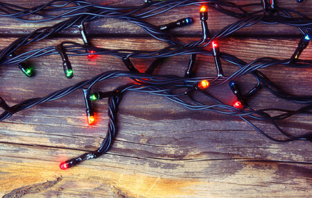 Colorful Christmas lights on wooden  rustic background. filtered imageの写真素材