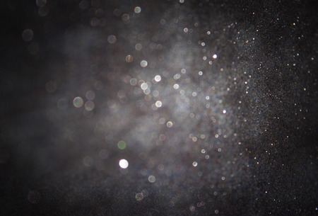 dark glitter vintage lights background. light silver and black. defocused.の写真素材