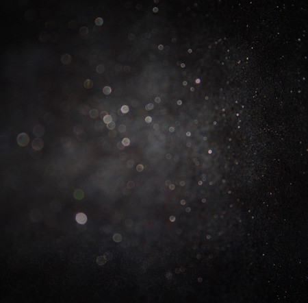 dark glitter vintage lights background. light silver and black. defocused.の写真素材