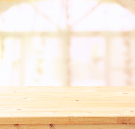 empty wooden table and window light background. filtered image. natural light.の写真素材