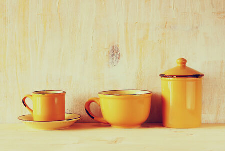 set of coffee mugs and old jar over wooden rustic table . filtered imageの写真素材