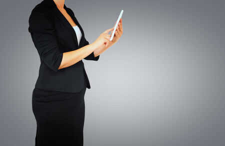 woman in business suit on gray elegant backgroundの写真素材