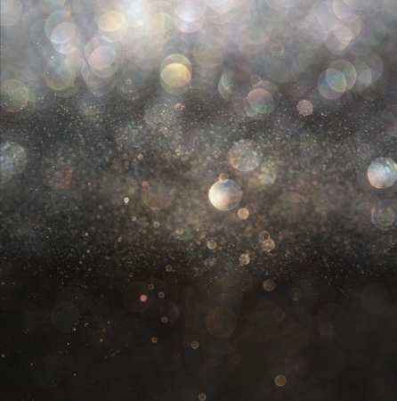 glitter vintage lights background. gold, silver, and black. de-focused.の写真素材
