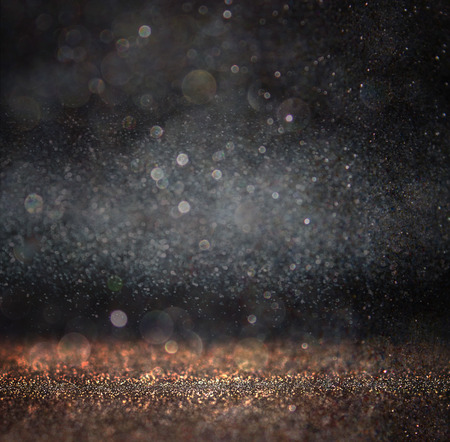 glitter vintage lights background. light gold and black. defocused.の写真素材