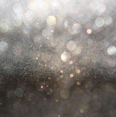 glitter vintage lights background. gold, silver, and black. de-focused.の写真素材