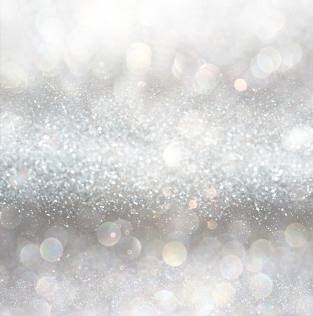 silver and white bokeh lights defocused. abstract backgroundの写真素材