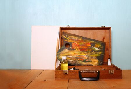 blank canvas or poster with wooden palette on on wooden table and textured backgroundの写真素材