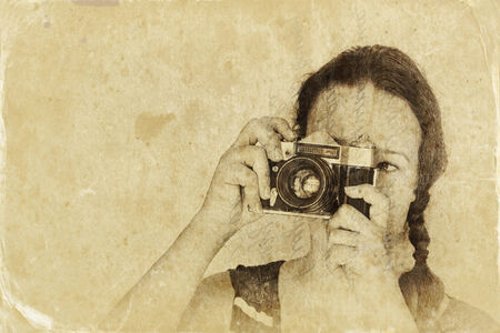young woman holding old camera. filtered image, old style photoの写真素材