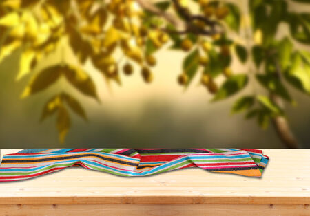 image of front rustic wood boards with towel against background of olive tree. の写真素材