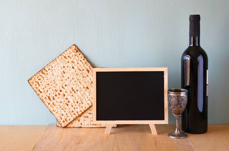 passover background. wine and matzoh (jewish passover bread) over wooden background.