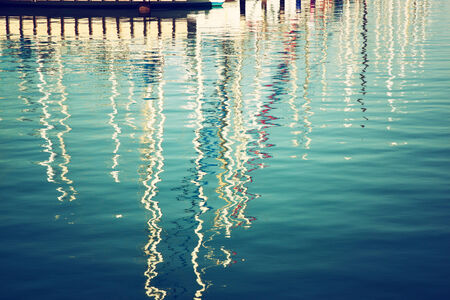 reflection in water boats. vintage filtered imageの写真素材