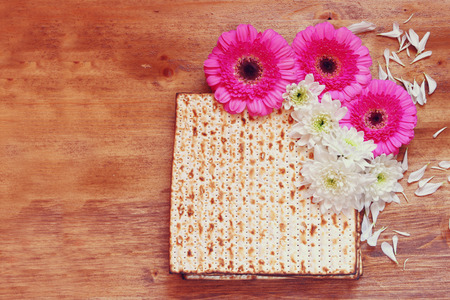 passover background. matzoh (jewish passover bread) and flowers on wooden tableの写真素材