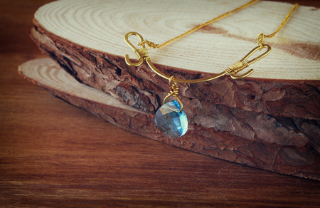 antique vintage necklace on wooden table. retro filtered imageの写真素材