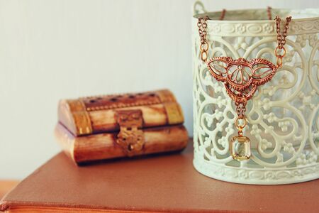antique vintage necklace on wooden table. retro filtered image. selective focusの写真素材