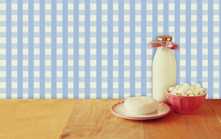 greek cheese , bulgarian cheese and milk on wooden table over rustic background. Symbols of jewish holiday - Shavuotの写真素材