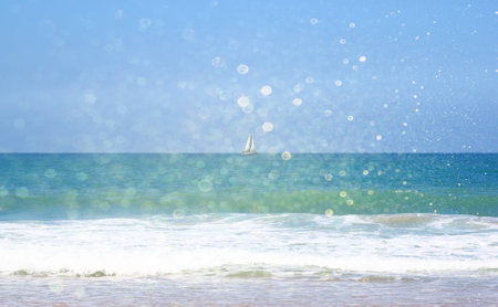 background of blurred beach and sea waves with bokeh lights, vintage filter.の写真素材