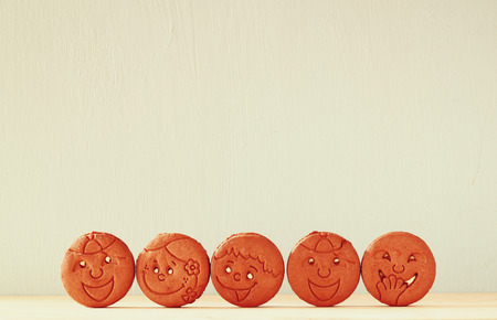 raw of cookies with smiley face over wooden tableの写真素材
