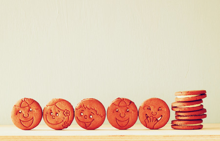 raw of cookies with smiley face over wooden tableの写真素材