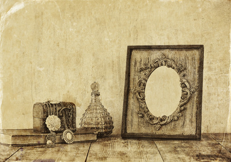 image of victorian vintage antique classical frame jewelry and perfume bottles on wooden table. old style photoの写真素材