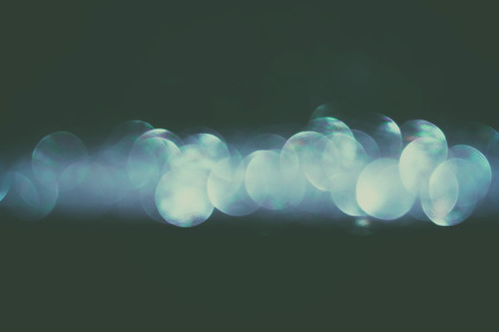 glitter vintage lights background.silver blue and black. defocused.の写真素材