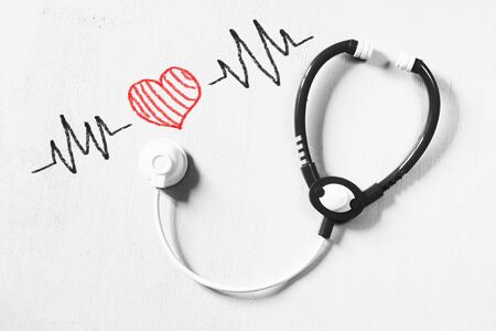Photo toy stethoscope and hert beats illustration over textured backgroundの写真素材