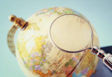 close up of old vintage globe and magnifying glassの写真素材
